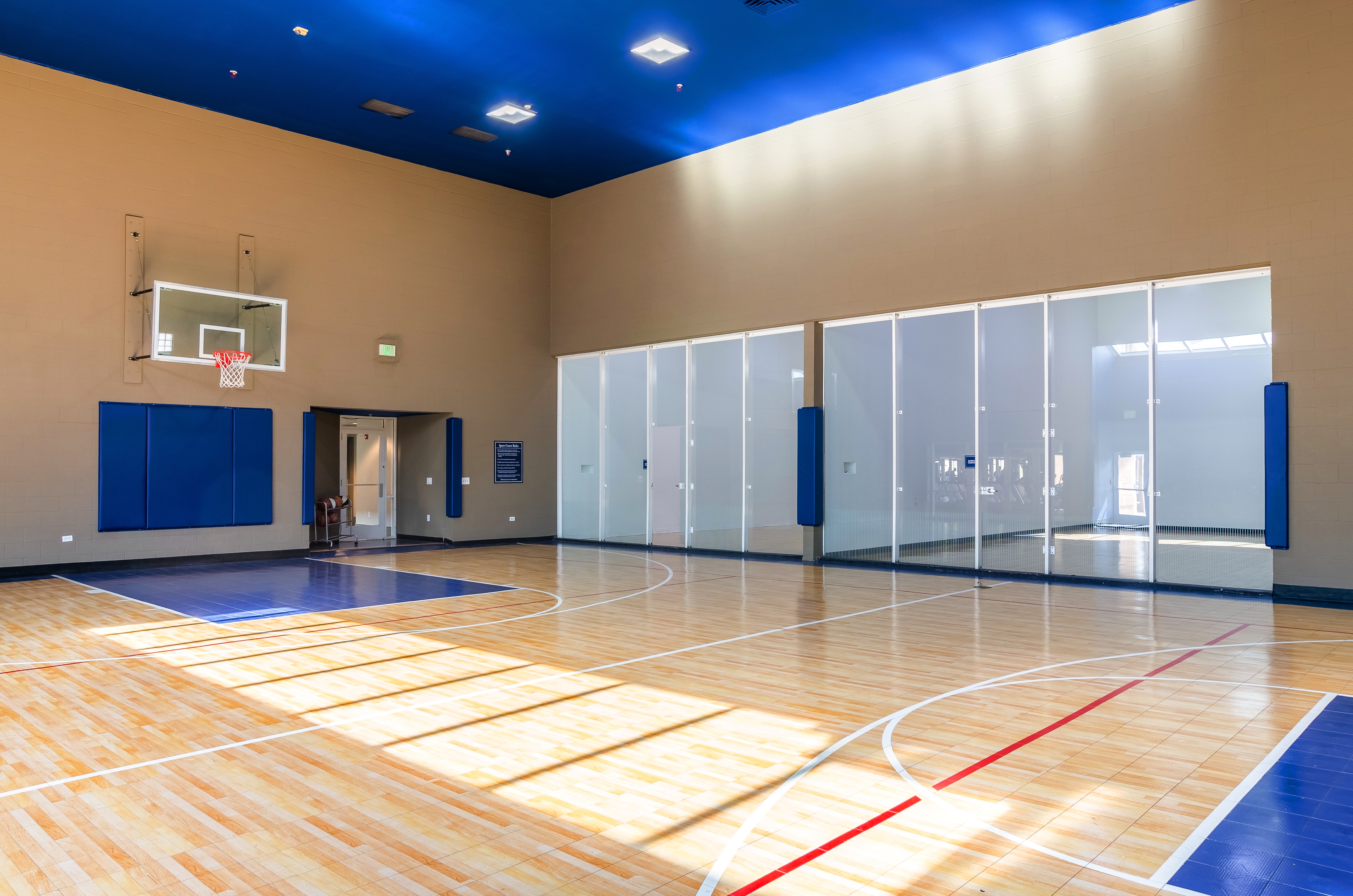 A basketball court with windows.